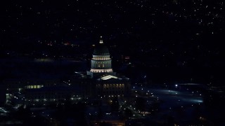 AX128_107E - 5.5K aerial stock footage of orbiting the Utah State Capitol with winter snow at night, Salt Lake City, Utah