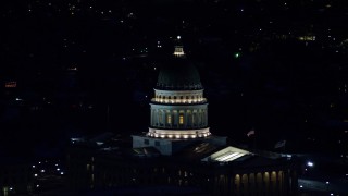AX128_109 - 5.5K aerial stock footage orbit dome of the Utah State Capitol at night in winter, Salt Lake City, Utah