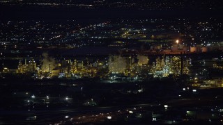 AX128_111 - 5.5K stock footage aerial video of orbiting a large refinery at night in wintertime, Salt Lake City, Utah
