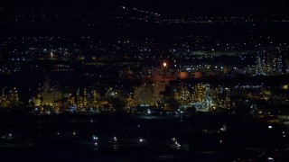 AX128_111E - 5.5K aerial stock footage of orbiting a large refinery at night in wintertime, Salt Lake City, Utah