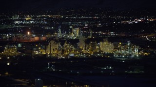 AX128_113 - 5.5K stock footage aerial video of circling a Salt Lake City refinery at night in winter, Utah