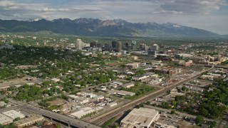 AX129_006E - 5.5K aerial stock footage flyby city buildings, homes, sports fields, Downtown Salt Lake City, Utah
