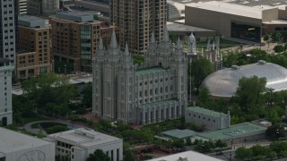 AX129_010 - 5.5K stock footage aerial video of flying by Salt Lake Temple and Mormon Tabernacle, Downtown Salt Lake City, Utah