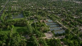 AX129_022 - 5.5K stock footage aerial video of flying over Liberty Park, tennis courts, approaching suburbs, Salt Lake City, Utah