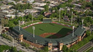 AX129_050 - 5.5K aerial stock footage orbit and tilt to Spring Mobile Ballpark during a baseball game, Salt Lake City, Utah