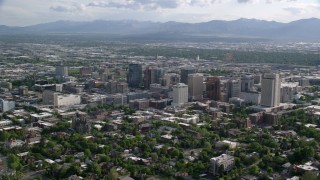 AX129_060 - 5.5K stock footage aerial video of flying by city buildings, distant Oquirrh Mountains, Downtown Salt Lake City, Utah
