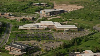 AX129_069E - 5.5K aerial stock footage of approaching University of Utah office building, tilt to bird's eye view, Salt Lake City
