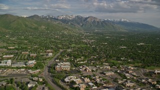 AX129_079E - 5.5K aerial stock footage of flying over suburbs, approaching Wasatch Range, Salt Lake City, Utah