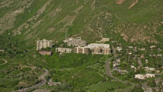 AX129_082E - 5.5K aerial stock footage video of passing by apartment buildings, Wasatch Range foothills, Salt Lake City, Utah
