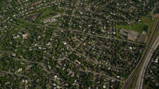 AX129_092E - 5.5K aerial stock footage bird's eye view suburban homes, green Wasatch Range slopes, Salt Lake City, Utah