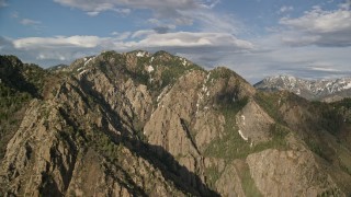 AX129_098E - 5.5K aerial stock footage of passing Mount Olympus, Wasatch Range, Utah