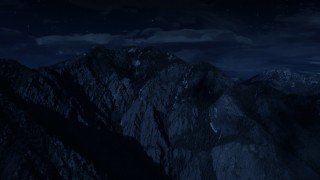 AX129_098_DFN - Aerial stock footage of 4K day for night color corrected aerial footage of flying by Mount Olympus, Wasatch Range, Utah