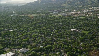AX129_140E - 5.5K aerial stock footage fly over suburbs, approach University of Utah sports fields, Salt Lake City, Utah
