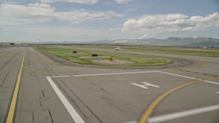 AX130_001E - 5.5K aerial stock footage of tracking an airplane taking off, Salt Lake City International Airport, Utah