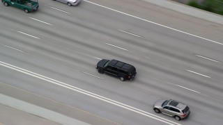 AX130_014 - 5.5K aerial stock footage track a black SUV on I-15, light traffic, Salt Lake City, Utah