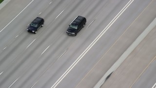 AX130_015 - 5.5K aerial stock footage of tracking SUVs on Interstate 15, light traffic, Salt Lake City, Utah