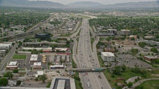 AX130_017E - 5.5K aerial stock footage of flying over I-15 and passing homes, Salt Lake City, Utah