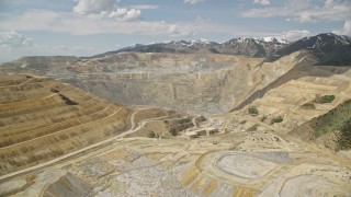 AX130_037E - 5.5K aerial stock footage orbit Bingham Canyon Mine (Kennecott Copper Mine), Utah