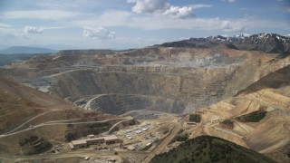 AX130_038 - 5.5K aerial stock footage orbit Bingham Canyon Mine (Kennecott Copper Mine), Utah