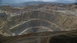 AX130_042 - 5.5K aerial stock footage orbiting the rim of Bingham Canyon Mine (Kennecott Copper Mine), Utah