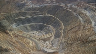 AX130_044 - 5.5K aerial stock footage of orbiting gravel haulers, Kennecott Copper Mine, Bingham Canyon Mine, Utah