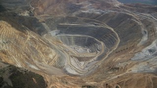 AX130_045 - 5.5K aerial stock footage orbit of gravel haulers, Kennecott Copper Mine aka Bingham Canyon Mine, Utah