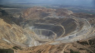 AX130_046 - 5.5K aerial stock footage of gravel haulers at Kennecott Copper Mine, aka Bingham Canyon Mine, Utah