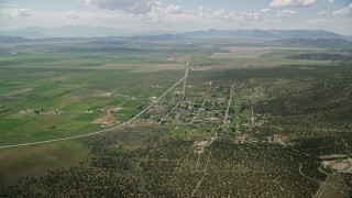 AX130_072E - 5.5K aerial stock footage approach and tilt to small town rural neighborhood, Cedar Fort, Utah