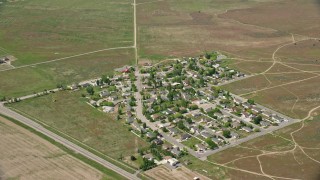AX130_076E - 5.5K aerial stock footage of flying by small rural neighborhood in Cedar Fort, Utah