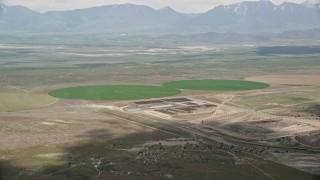 AX130_089E - 5.5K aerial stock footage video of two green circular crop fields, Elberta, Utah
