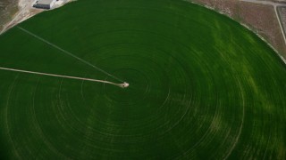 AX130_094 - 5.5K aerial stock footage of flying by circular crop field, irrigation system, Elberta, Utah