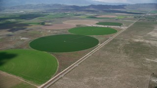 AX130_095 - 5.5K aerial stock footage of approaching circular crop fields, access road, Elberta, Utah