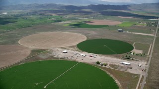 AX130_097 - 5.5K aerial stock footage of approaching, flying over large circular crop fields, Elberta, Utah
