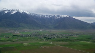 AX130_109 - 5.5K aerial stock footage of a small rural town near the base of Wasatch Range, Mona, Utah