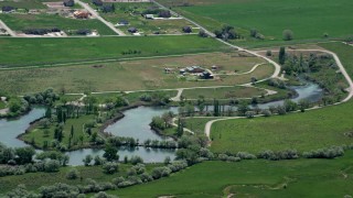 AX130_112 - 5.5K aerial stock footage of a barn and Burraston Ponds, Mona, Utah