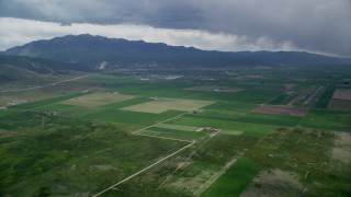 AX130_115 - 5.5K stock footage aerial video of approaching small rural town, farmland, Nephi Municipal Airport, Nephi, Utah