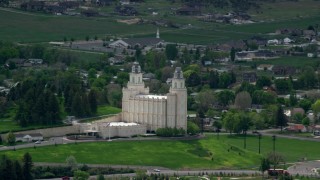 AX130_145 - 5.5K stock footage aerial video of orbiting the Manti-Utah Temple near neighborhoods, Manti, Utah
