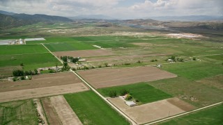 AX130_147E - 5.5K aerial stock footage of flying over farmland near Gunnison Reservoir, Manti, Utah