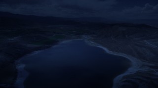 AX130_154_DFN - Aerial stock footage of 4K day for night color corrected aerial footage fly over the Gunnison Reservoir, low water, approach farms, Sterling, Utah