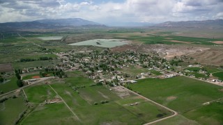 AX130_161 - 5.5K stock footage aerial video of approaching a rural town, farms, and Redmond Lake, Redmond, Utah