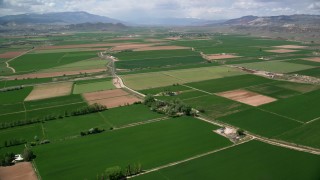 AX130_164 - 5.5K aerial stock footage of flying over farmland, rural roads, Aurora, Utah