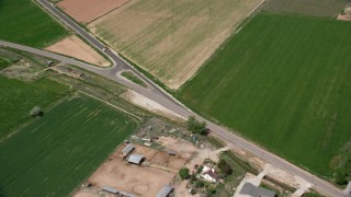 AX130_172 - 5.5K aerial stock footage of flying by rural homes, Old Highway 89, Aurora, Utah