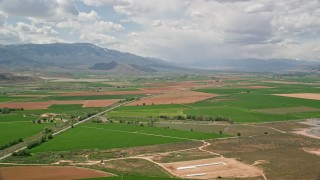 AX130_181 - 5.5K aerial stock footage of approaching rural town, near a bend in Route 118, Venice, Utah