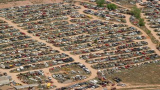 AX130_183 - 5.5K aerial stock footage of cars in an auto junkyard, Sigurd, Utah