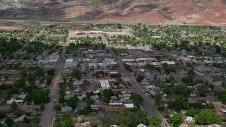 AX130_195 - 5.5K stock footage aerial video of passing by shops, small town neighborhoods, Richfield, Utah