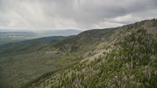 AX130_206E - 5.5K aerial stock footage of flying by mountain slopes, aspen and evergreen trees, Fishlake National Forest, Utah