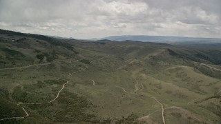 AX130_218E - 5.5K aerial stock footage fly over dirt roads through the hills, Fishlake National Forest, Utah