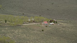 AX130_220 - 5.5K aerial stock footage of flying over isolated rural homes, Fishlake National Forest, Utah