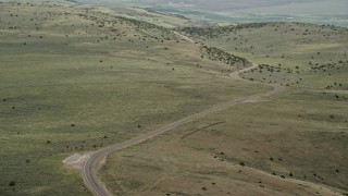 AX130_221E - 5.5K aerial stock footage of flying by deserted road through the hills, Fishlake National Forest, Utah
