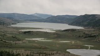 AX130_223E - 5.5K aerial stock footage of passing by Quaking Giant aspen tree colony, Pando, Fish Lake, Utah